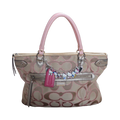 Handbag with decorative charms on a white background